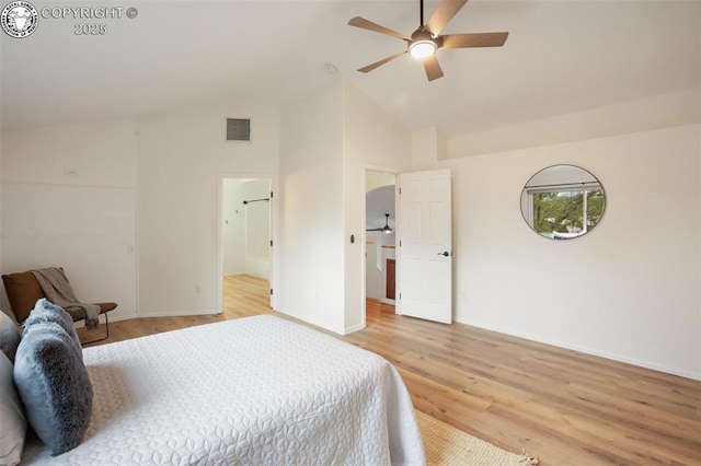 bedroom featuring baseboards, light wood-type flooring, high vaulted ceiling, and visible vents
