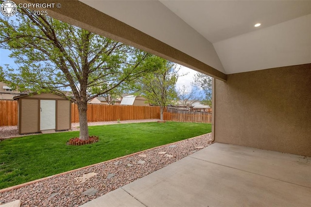 view of yard with a fenced backyard, a patio, an outdoor structure, and a storage shed