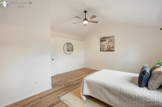 bedroom with baseboards, vaulted ceiling, ceiling fan, and light wood finished floors