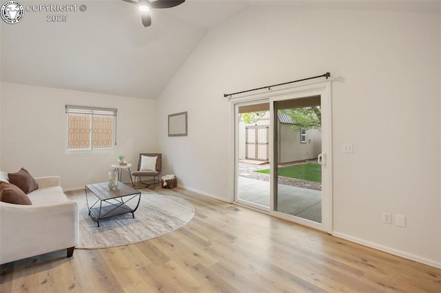 living room featuring baseboards, ceiling fan, wood finished floors, and high vaulted ceiling