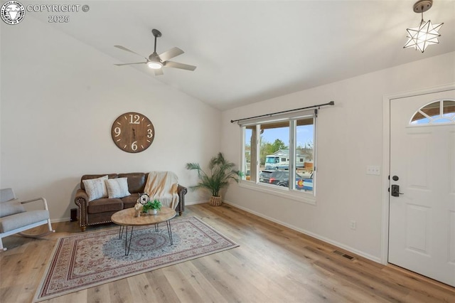 foyer entrance with ceiling fan, vaulted ceiling, a wealth of natural light, and visible vents