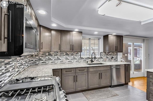 855 5th St, Penrose, CO 81240 - kitchen with appliances with stainless steel finishes, a sink, decorative backsplash, healthy amount of natural light, and recessed lighting