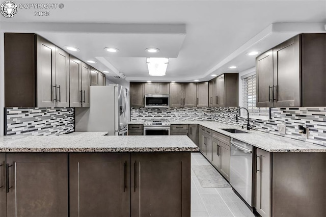 855 5th St, Penrose, CO 81240 - kitchen with stainless steel appliances, a sink, tasteful backsplash, recessed lighting, and a peninsula