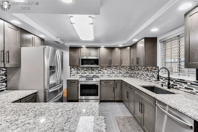 855 5th St, Penrose, CO 81240 - kitchen with stainless steel appliances, a sink, backsplash, light stone countertops, and recessed lighting