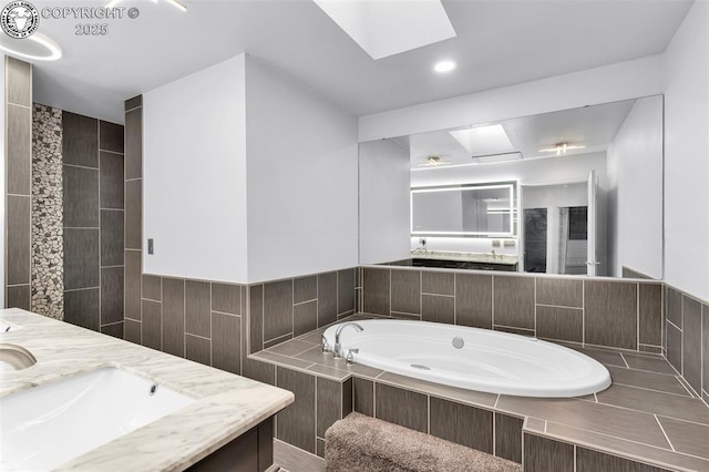 855 5th St, Penrose, CO 81240 - bathroom featuring a skylight, double vanity, and a bath