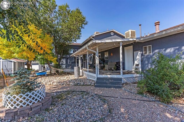 855 5th St, Penrose, CO 81240 - rear view of property featuring stucco siding, central air condition unit, and a deck