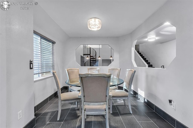 855 5th St, Penrose, CO 81240 - dining room with stairway, baseboards, and a chandelier