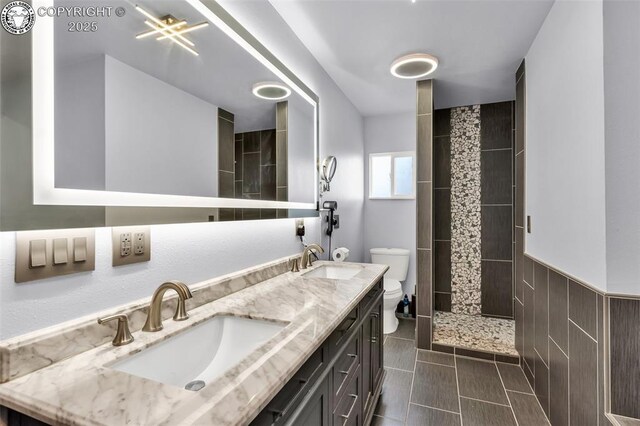 855 5th St, Penrose, CO 81240 - full bathroom featuring toilet, a tile shower, and double vanity