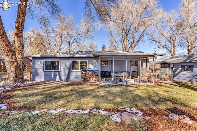 back of property featuring a patio and a yard