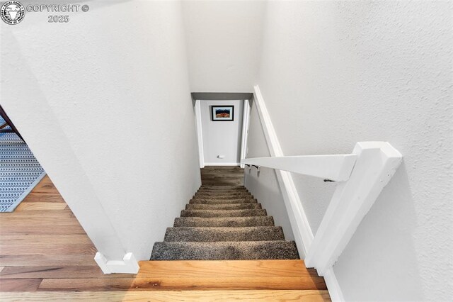 stairs with wood-type flooring