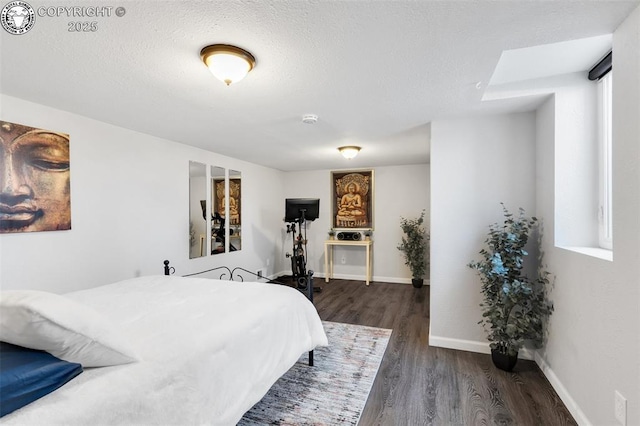 bedroom featuring dark hardwood / wood-style floors and a textured ceiling