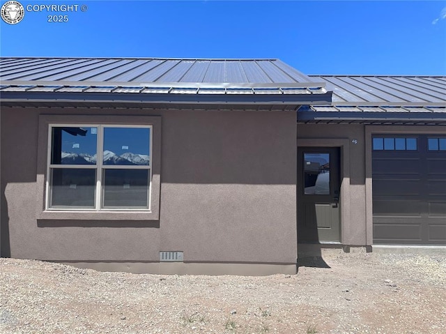55 Kryptonite Ct, Westcliffe, CO 81252 - view of home's exterior with a standing seam roof, a metal roof, an attached garage, and stucco siding