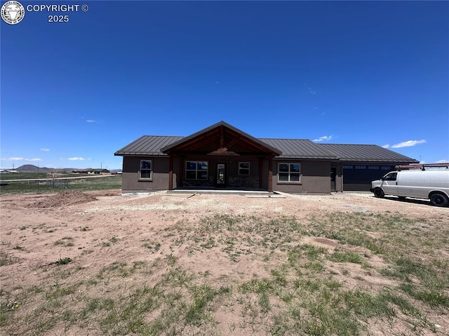 55 Kryptonite Ct, Westcliffe, CO 81252 - rear view of property with a metal roof, an attached garage, and stucco siding