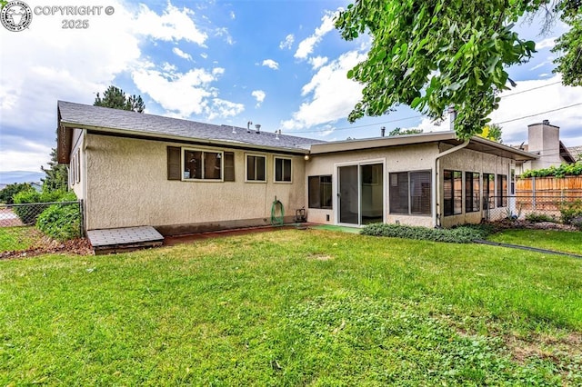 1035 Ohio Ave, Canon City, CO 81212 - back of property featuring stucco siding and a sunroom