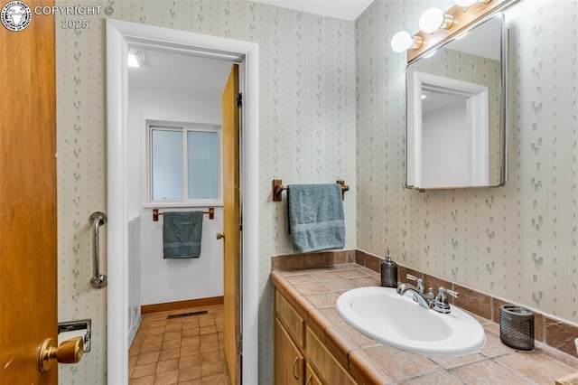 1035 Ohio Ave, Canon City, CO 81212 - bathroom featuring wallpapered walls, vanity, and tile patterned floors