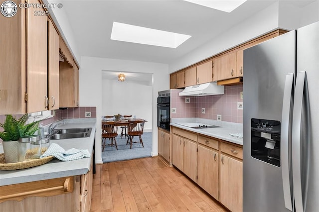 1035 Ohio Ave, Canon City, CO 81212 - kitchen with stainless steel fridge, a skylight, light countertops, black oven, and stovetop