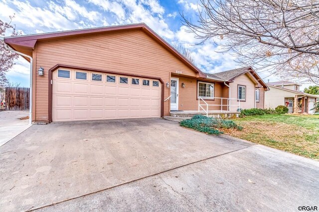 ranch-style house with a garage and a front lawn