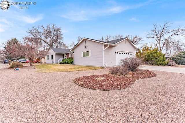 view of home's exterior featuring a lawn, driveway, and an attached garage