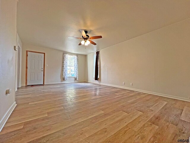 spare room with ceiling fan and light hardwood / wood-style flooring