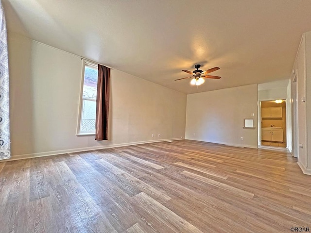 unfurnished room featuring ceiling fan and light hardwood / wood-style floors