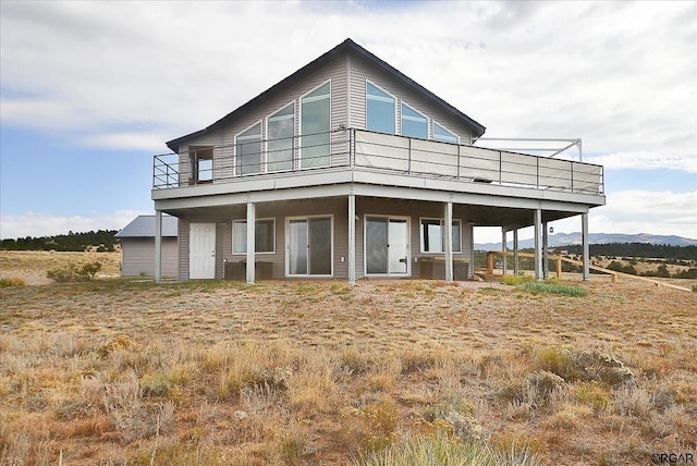 back of house with a wooden deck