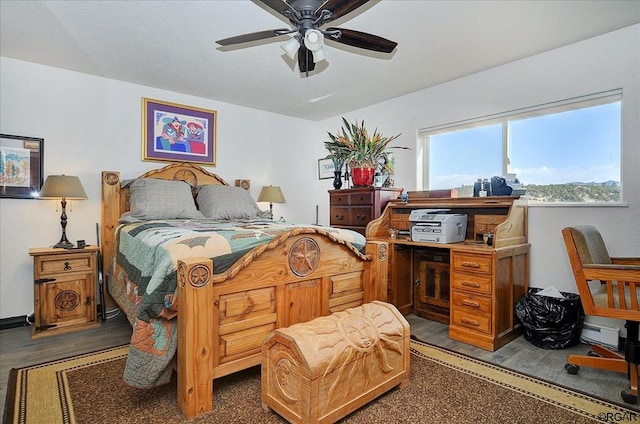 bedroom featuring dark hardwood / wood-style flooring and ceiling fan