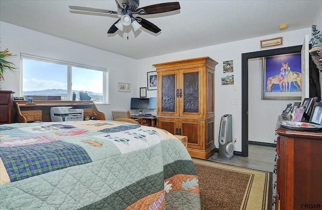 bedroom with ceiling fan and wood-type flooring