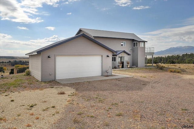 view of front of home featuring a garage and a mountain view