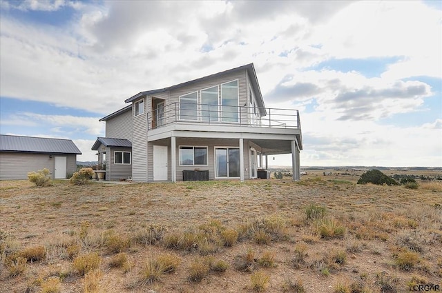 rear view of property featuring central AC