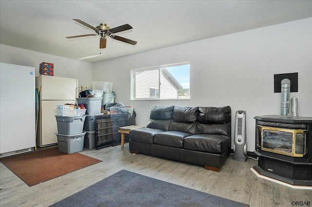 living room featuring ceiling fan and light wood-type flooring