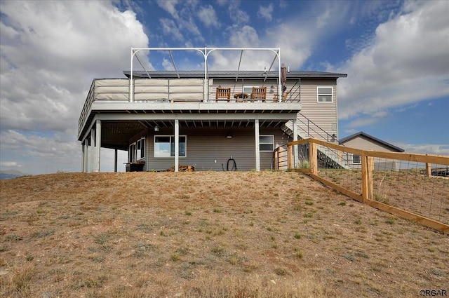 rear view of property featuring a deck