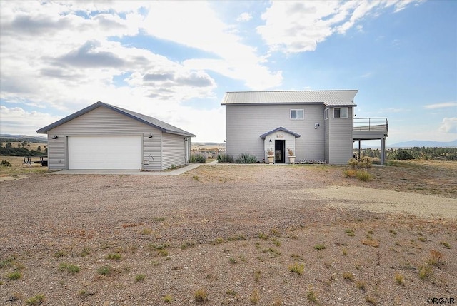 back of property featuring a garage and an outdoor structure