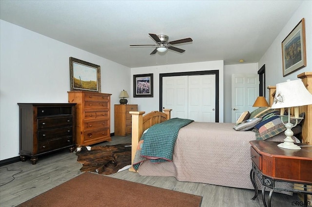 bedroom with wood-type flooring, ceiling fan, and a closet