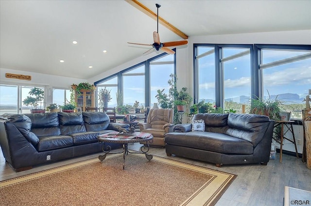 living room featuring hardwood / wood-style flooring, lofted ceiling, and ceiling fan