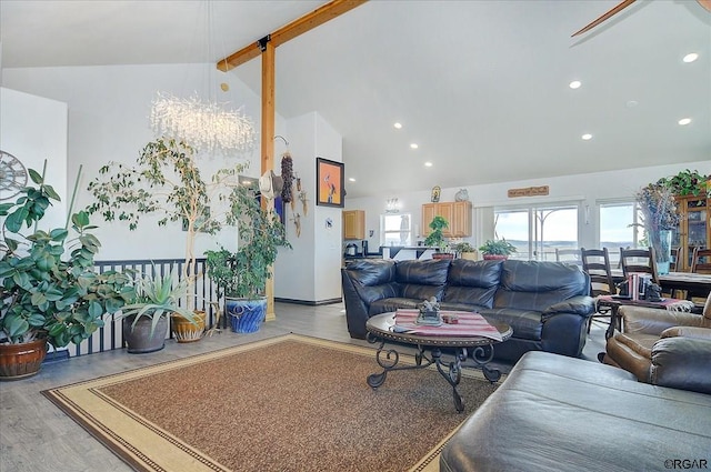 living room featuring lofted ceiling with beams and light wood-type flooring