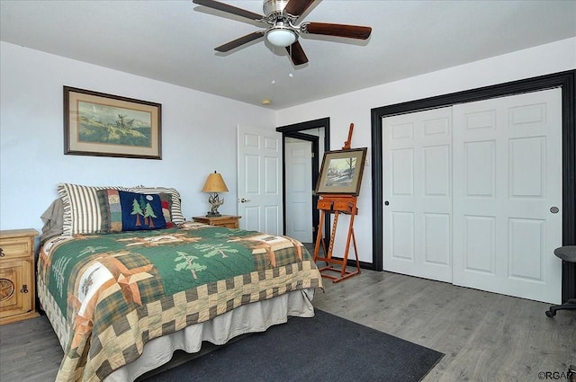 bedroom with hardwood / wood-style floors, a closet, and ceiling fan