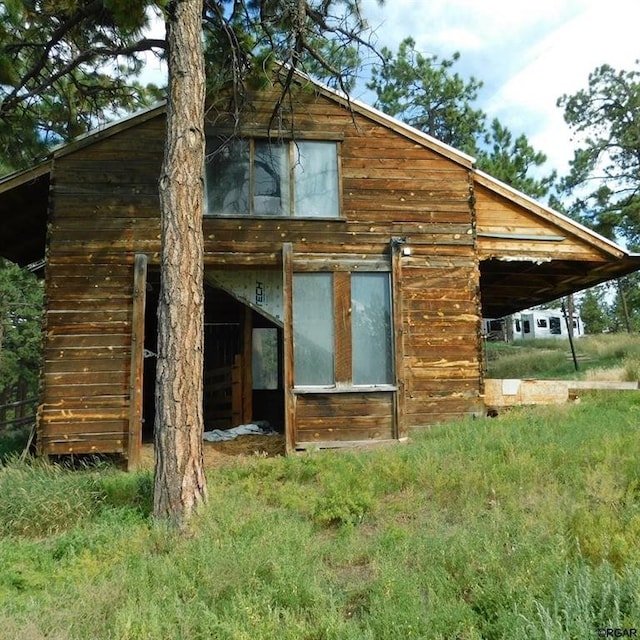 view of property exterior with an outbuilding