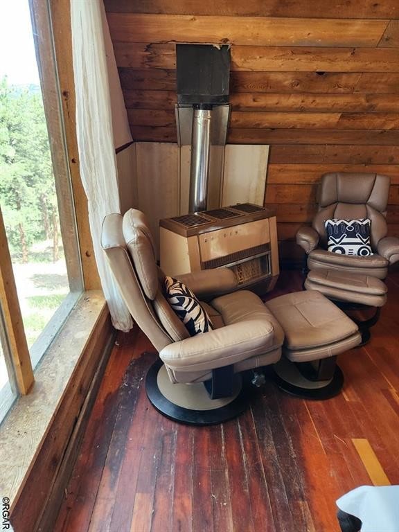 sitting room featuring hardwood / wood-style flooring, vaulted ceiling, and plenty of natural light