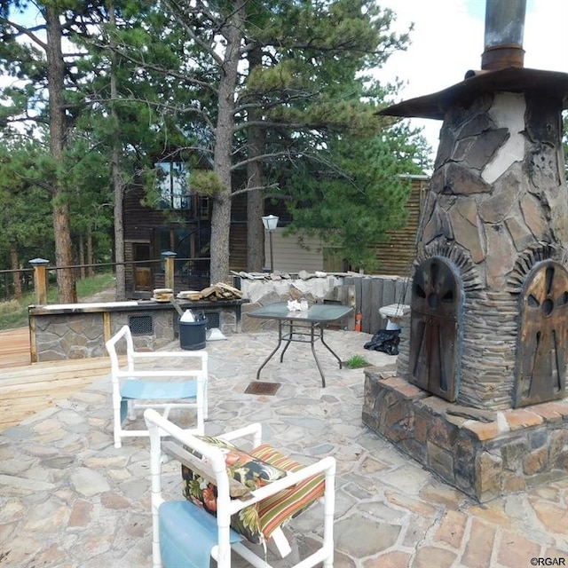 view of patio / terrace with an outdoor stone fireplace