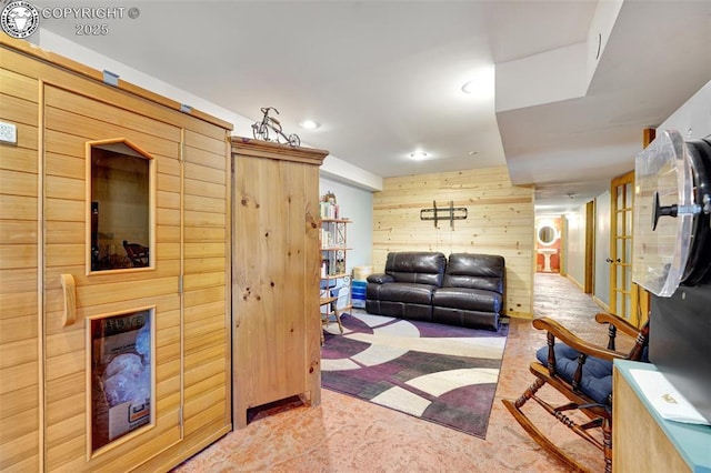 living room featuring wooden walls and recessed lighting