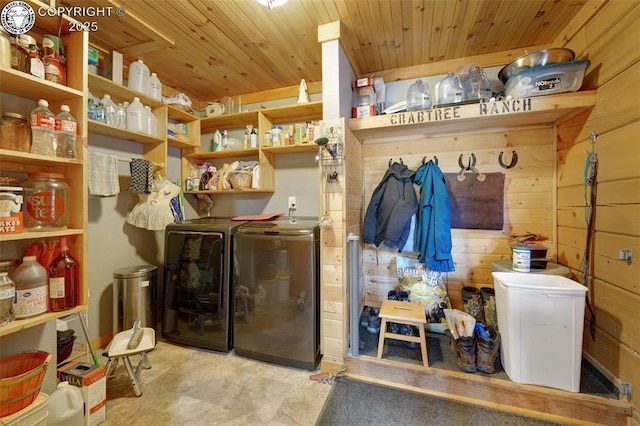 laundry room featuring independent washer and dryer, wood walls, wooden ceiling, and laundry area