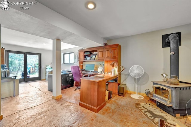 home office featuring french doors, a wood stove, and baseboards