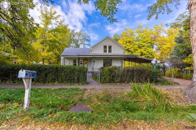 view of front facade with a fenced front yard, covered porch, and a chimney