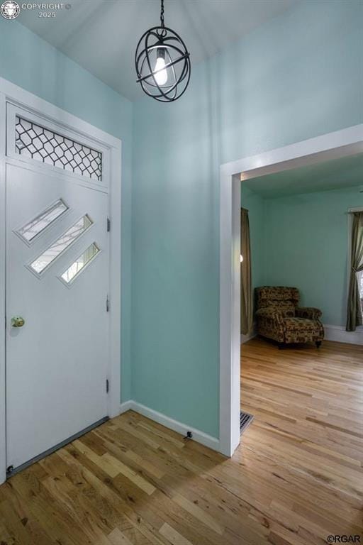 entrance foyer featuring light wood-type flooring and baseboards