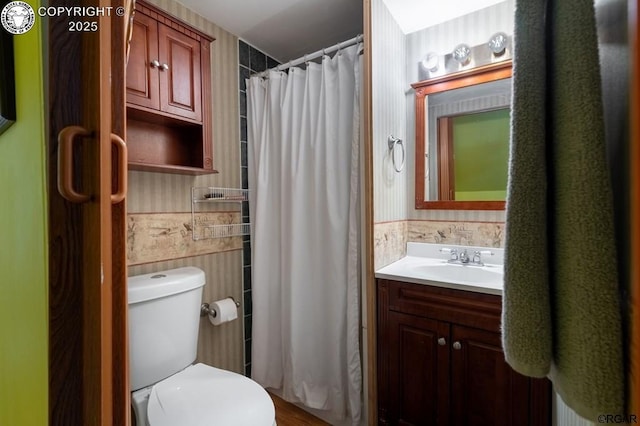 full bath featuring a wainscoted wall, toilet, tile walls, and vanity