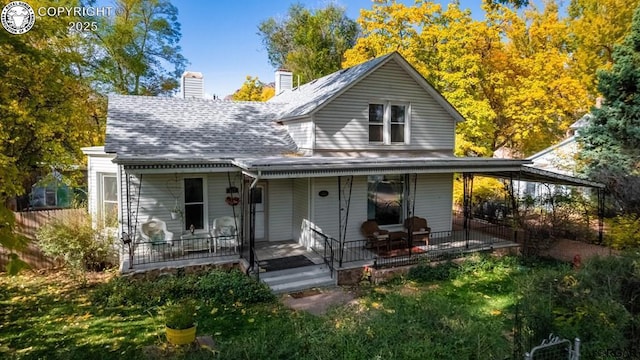 view of front of property featuring a shingled roof, covered porch, and a chimney