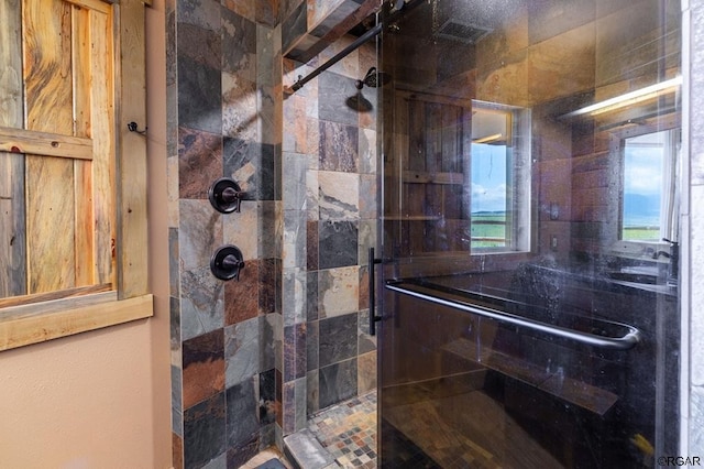 bathroom with a shower with shower door