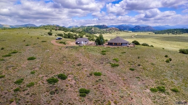 drone / aerial view featuring a mountain view and a rural view