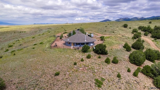 birds eye view of property with a mountain view and a rural view