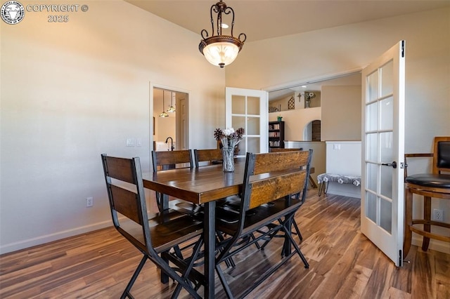 dining space featuring hardwood / wood-style floors and french doors